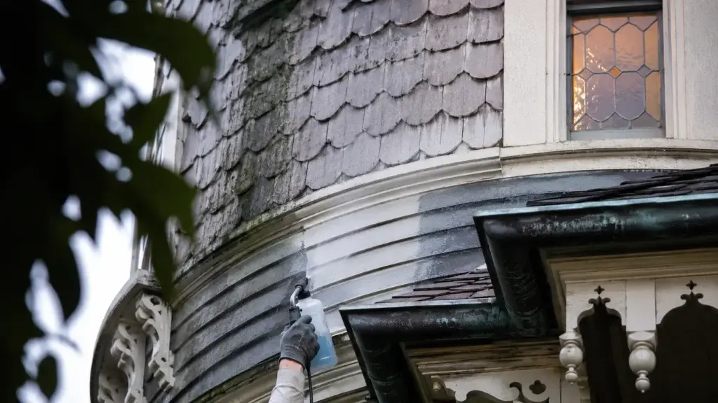 Gentle soft washing protects the ornate cedar shingles and original trim of an older home.